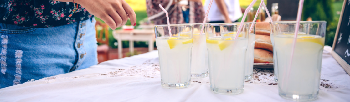 Friends sip on healthy, homemade lemonade at an outdoor gathering.