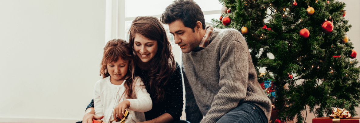 A family opens presents together on Christmas morning.