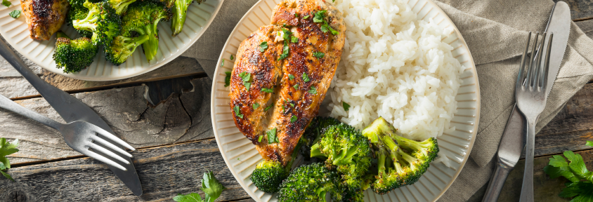 Chicken, instant rice, and roasted frozen vegetables displayed on a plate. 