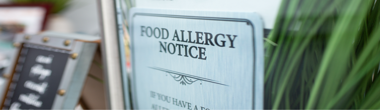 A food allergy notice sign sits in a restaurant. 