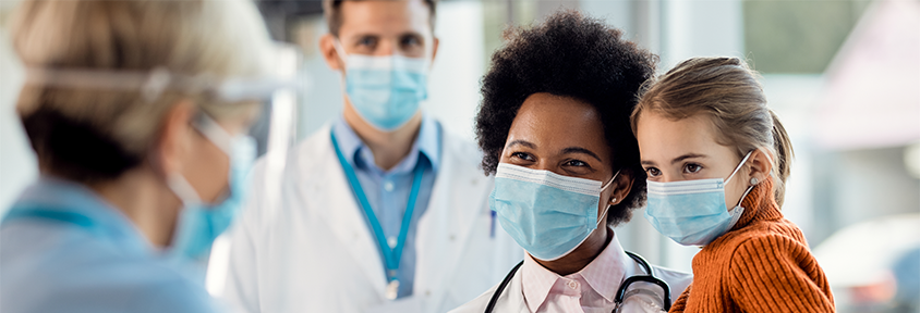 A physician assistant and nurse care for a child at a convenient care clinic.