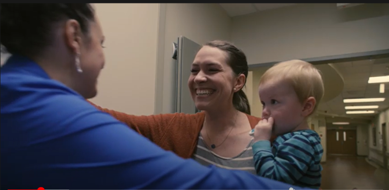 Anna Fleming holds her son, Matthew, while hugging a Labor & Delivery nurse.