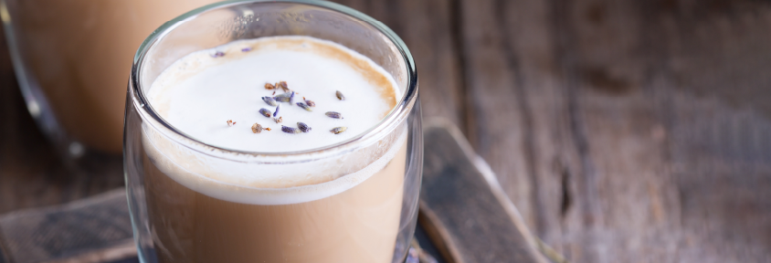 A mug of lavender chamomile moon milk sits on a saucer. 