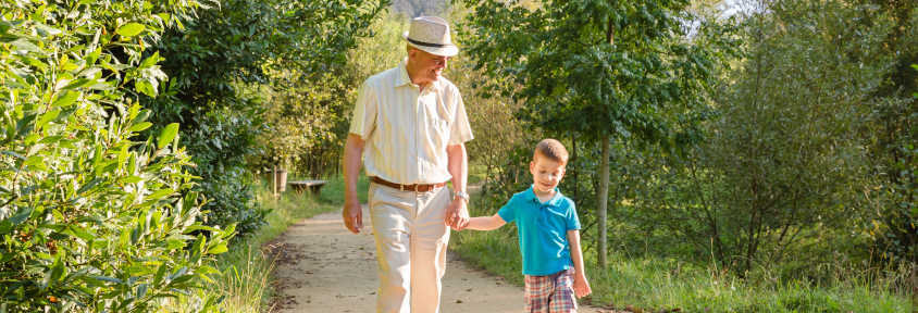 A man and his grandchild walk after platelet-rich plasma helped reduce his osteoarthritis pain. 