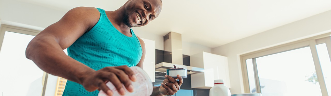 A man prepares a cherry and spinach smoothie to refuel after his workout.