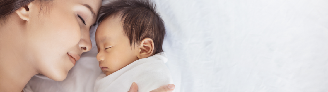 A woman and her baby sleep nose-to-nose