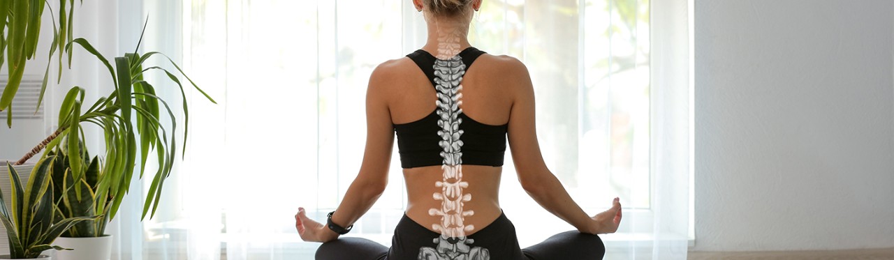 A woman sitting with good posture on a yoga mat, with an illustration of a spine on her back