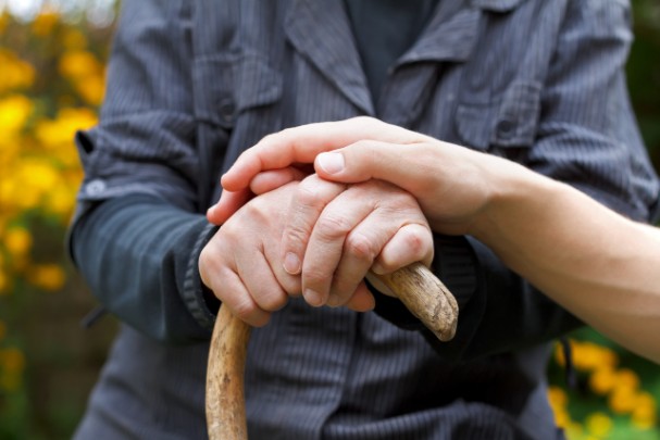 Woman comforting elderly man