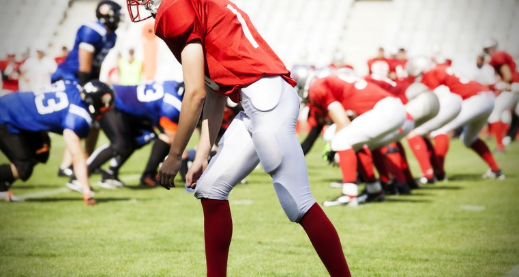 Teen football players face off on the field 