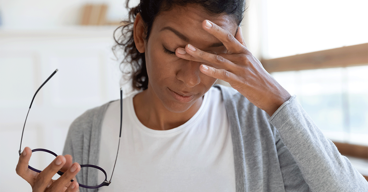 Woman experiences brain fog, a neurological symptom related to COVID-19.
