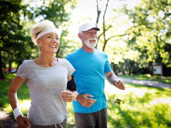 Senior couple jogging together outside