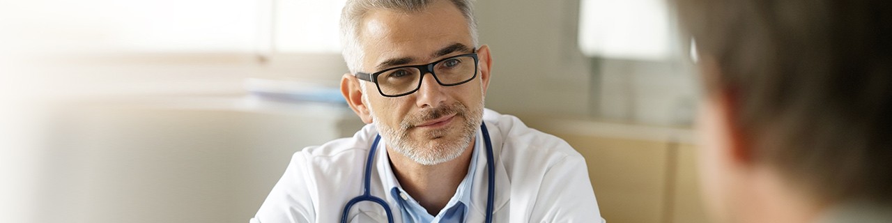 Male physician speaking with a patient
