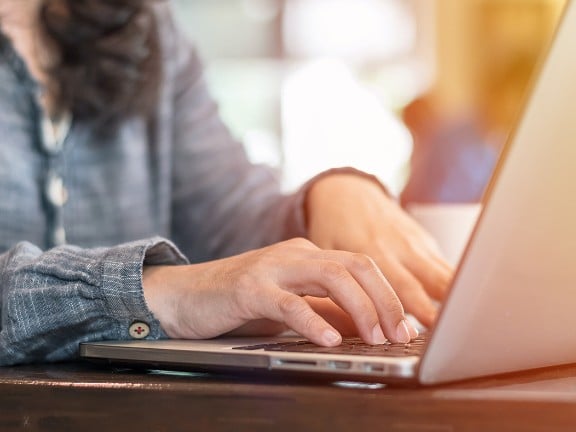 woman typing on her computer