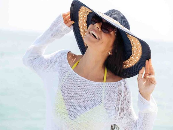 Woman wearing a hat on the beach