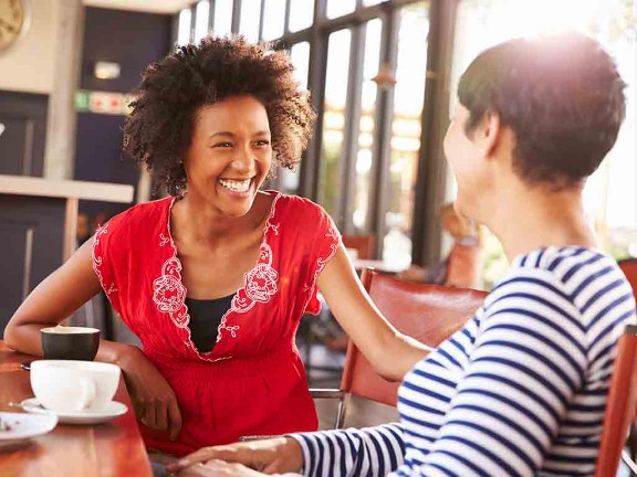 Two women talking in a coffee shop