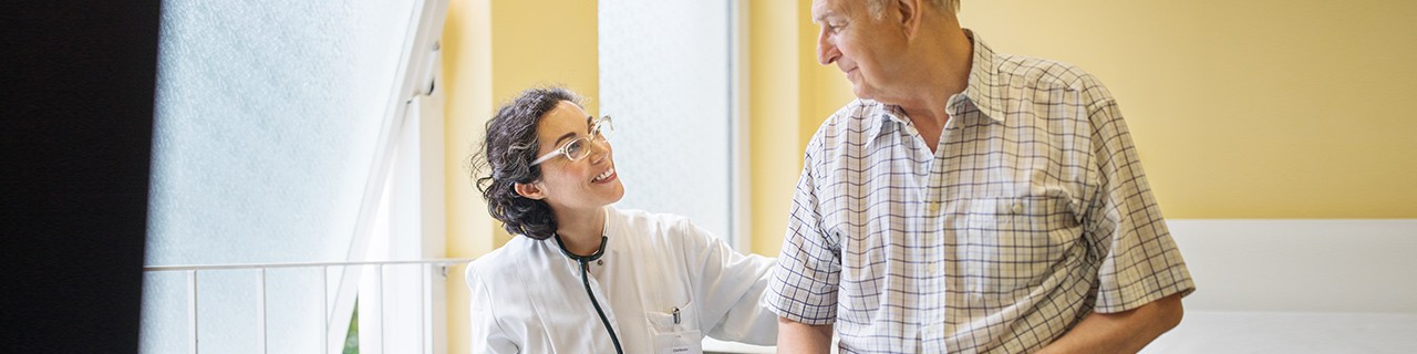 Female physician helping an older man