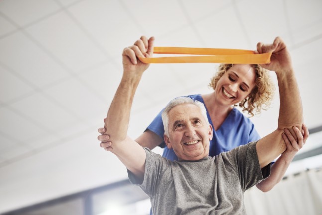 Man doing rehab stretches with nurse