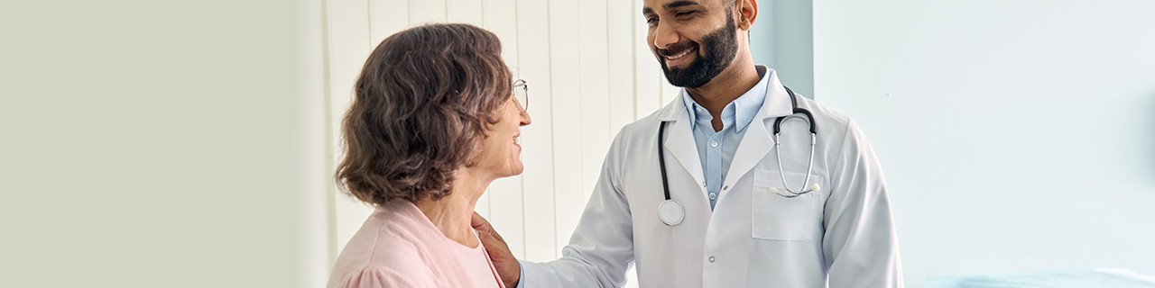 Male physician smiling at his female patient