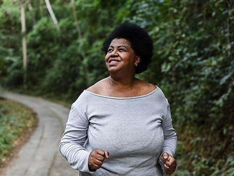 A woman embracing the outdoors while she jogs