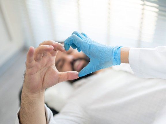 Patient and medical provider making a heart shape with their hands