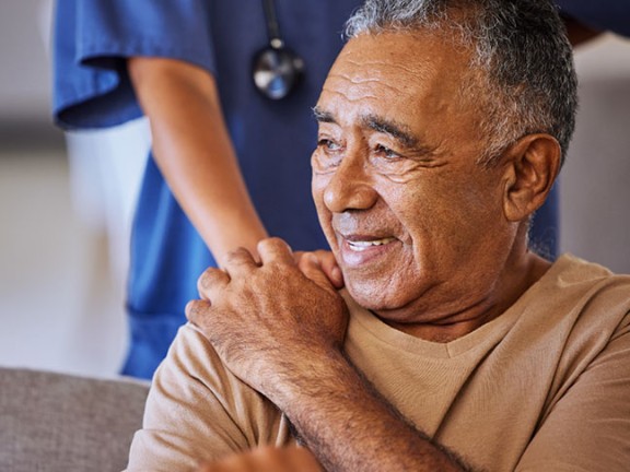 Elderly man and nurse acknowledging each other 