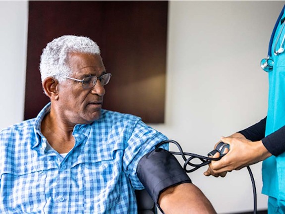 Patient looking at blood pressure machine