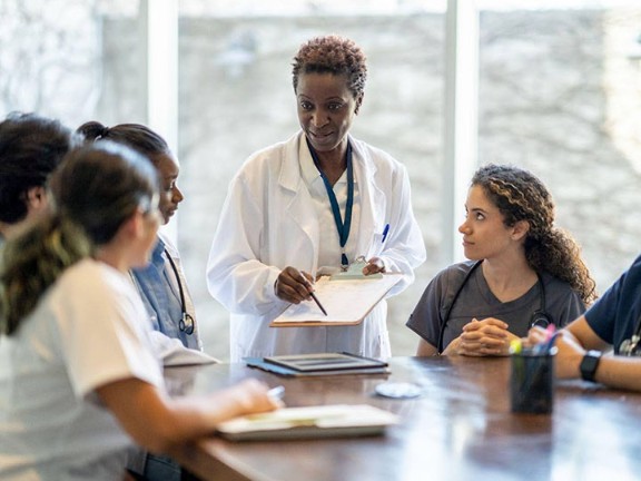 Physician speaking with nursing team