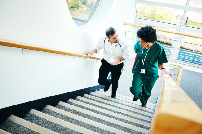 Physician and nurse walking upstairs