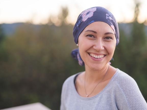 A portrait of a woman smiling outside 