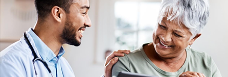 Doctor talking to a patient smiling.