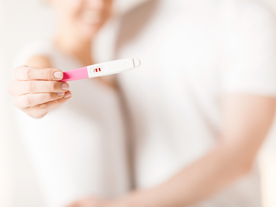 Woman looking at pregnancy test