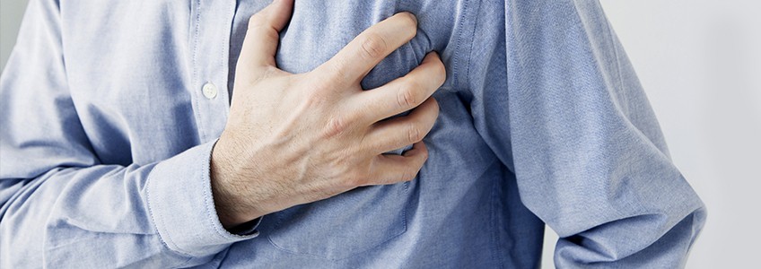 Man clutching left side of chest