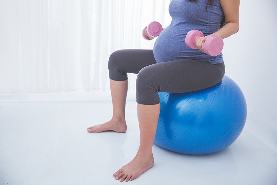 Pregnant woman exercising on an exercise ball