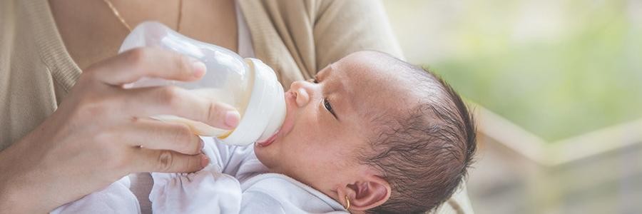 A mother feeding her baby from a bottle