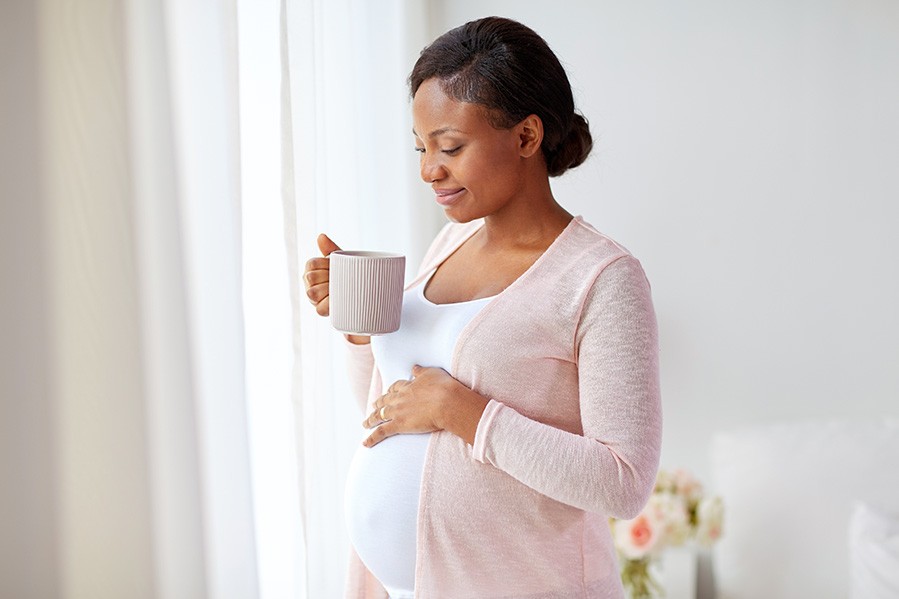 Pregnant woman holding a mug