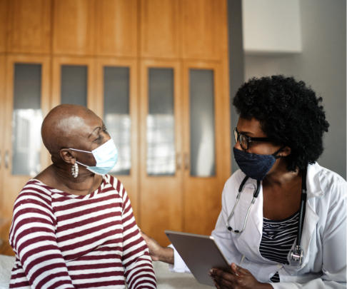 A cancer patient and her oncologist discuss the next steps in her treatment plan.