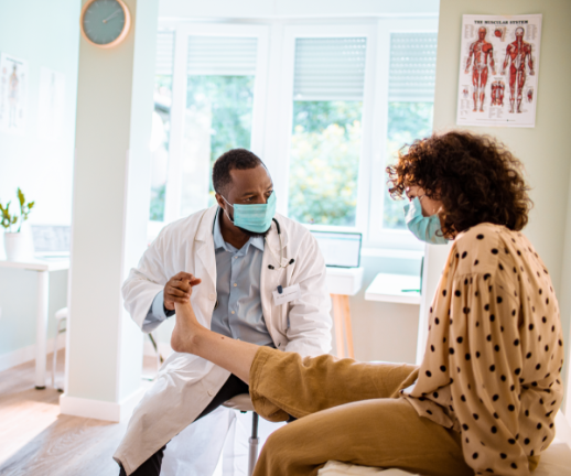 A pain management specialist works with a patient to help relieve the pain in her ankle. 