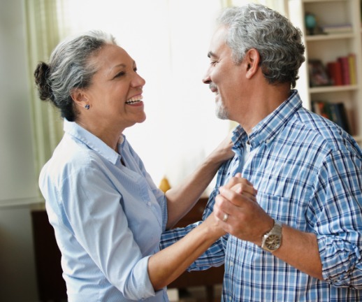 A man dances with his spouse in their home after receiving good news from his endocrinologist.