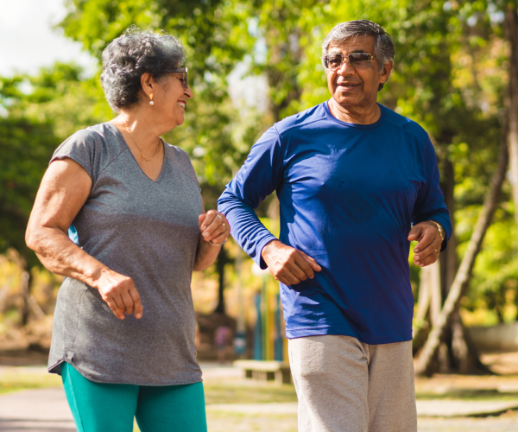 A married couple goes on an afternoon walk to keep up a healthy lifestyle.