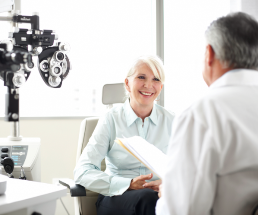 An ophthalmologist talks with his female patient about her eye health.