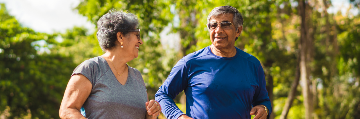 Older couple walking together outside