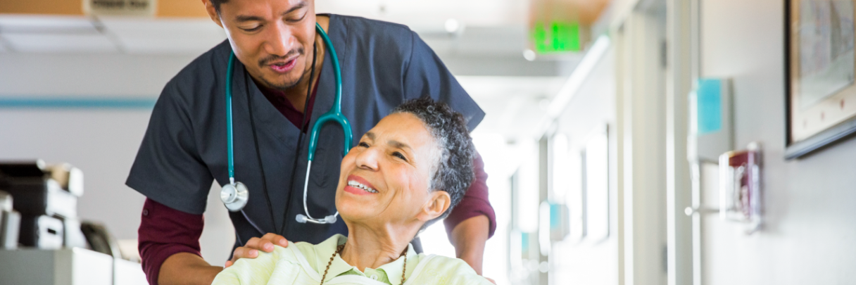 Financial Counseling for Transplant Patients in Houston A male nurse escorts a female patient to her room as she recovers from receiving her transplant.