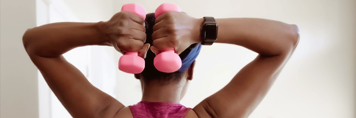 A woman performs shoulder exercises to try to strengthen her back and take care of her spine.