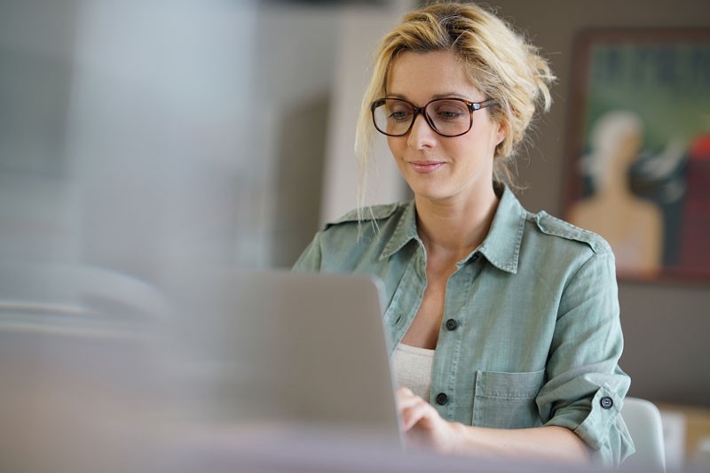 woman looking at her computer