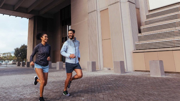 A happy couple jogging outside