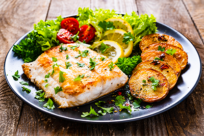 Baked lemon parsley cod with a side of roasted vegetables, a pescetarian recipe for Lent