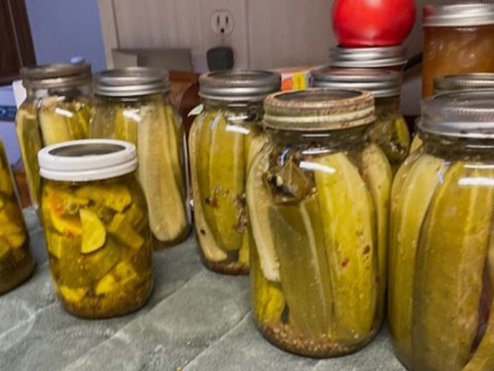 A jar full of home made pickles. 