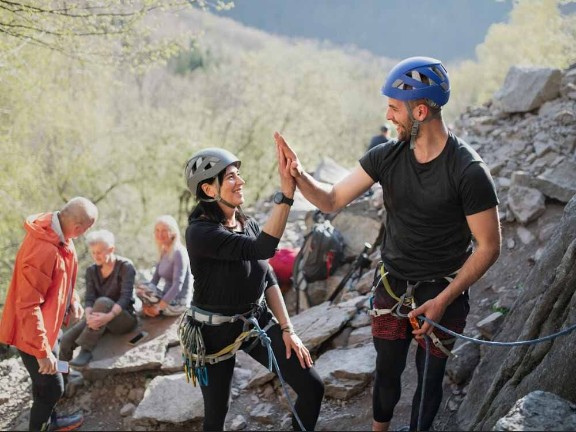 Rock climber high fiving