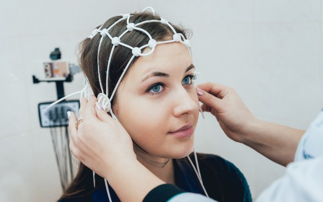 Is Medication the Only Treatment Option for Epilepsy? | St. Luke's Health A doctor uses an electroencephalogram to track electrical activity in a girl's brain