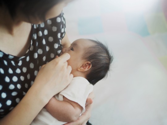 A mom holds her baby close 